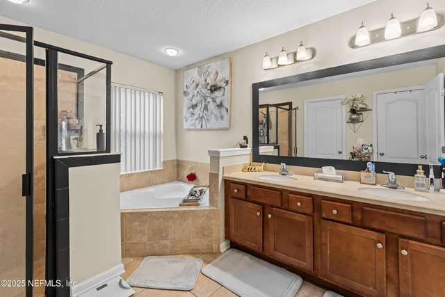 a bathroom with a tub sink and mirror