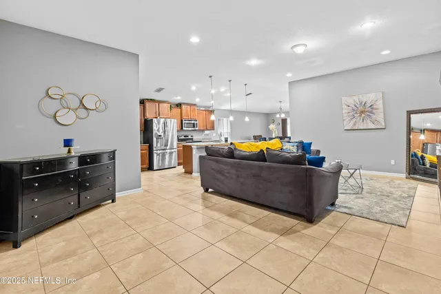 a kitchen with stainless steel appliances granite countertop a refrigerator and a stove top oven