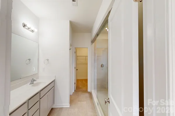 a bathroom with a double vanity sink and a mirror