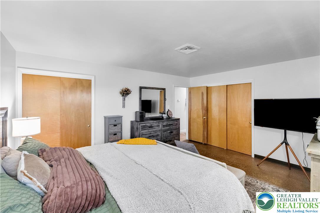 5747 Kernsville Road Orefield, PA 18069 - Photo 28 of 56 a bedroom with a bed and a flat tv screen on dresser