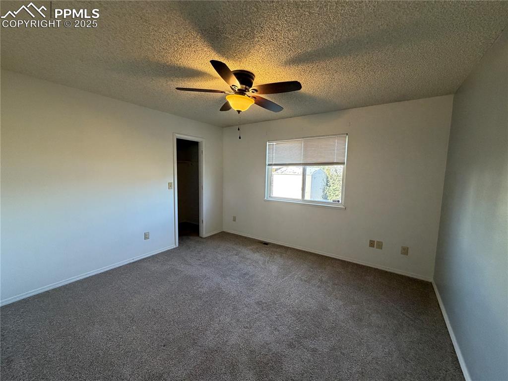 770 Memory Lane Fountain, CO 80817 - Photo 11 of 21 an empty room with windows and fan chandelier fan