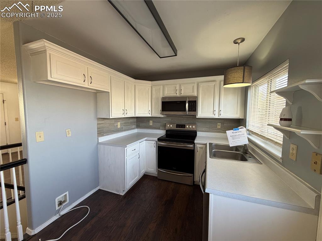 770 Memory Lane Fountain, CO 80817 - Photo 10 of 21 a kitchen with granite countertop a refrigerator stove and microwave