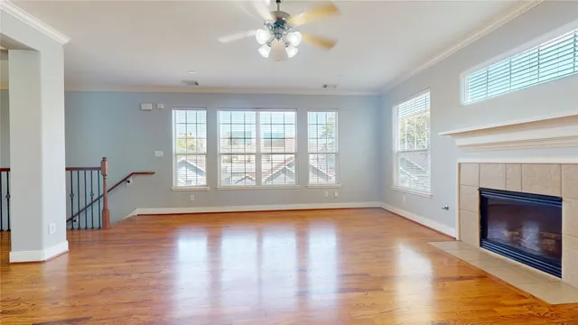 a view of empty room with wooden floor and fireplace