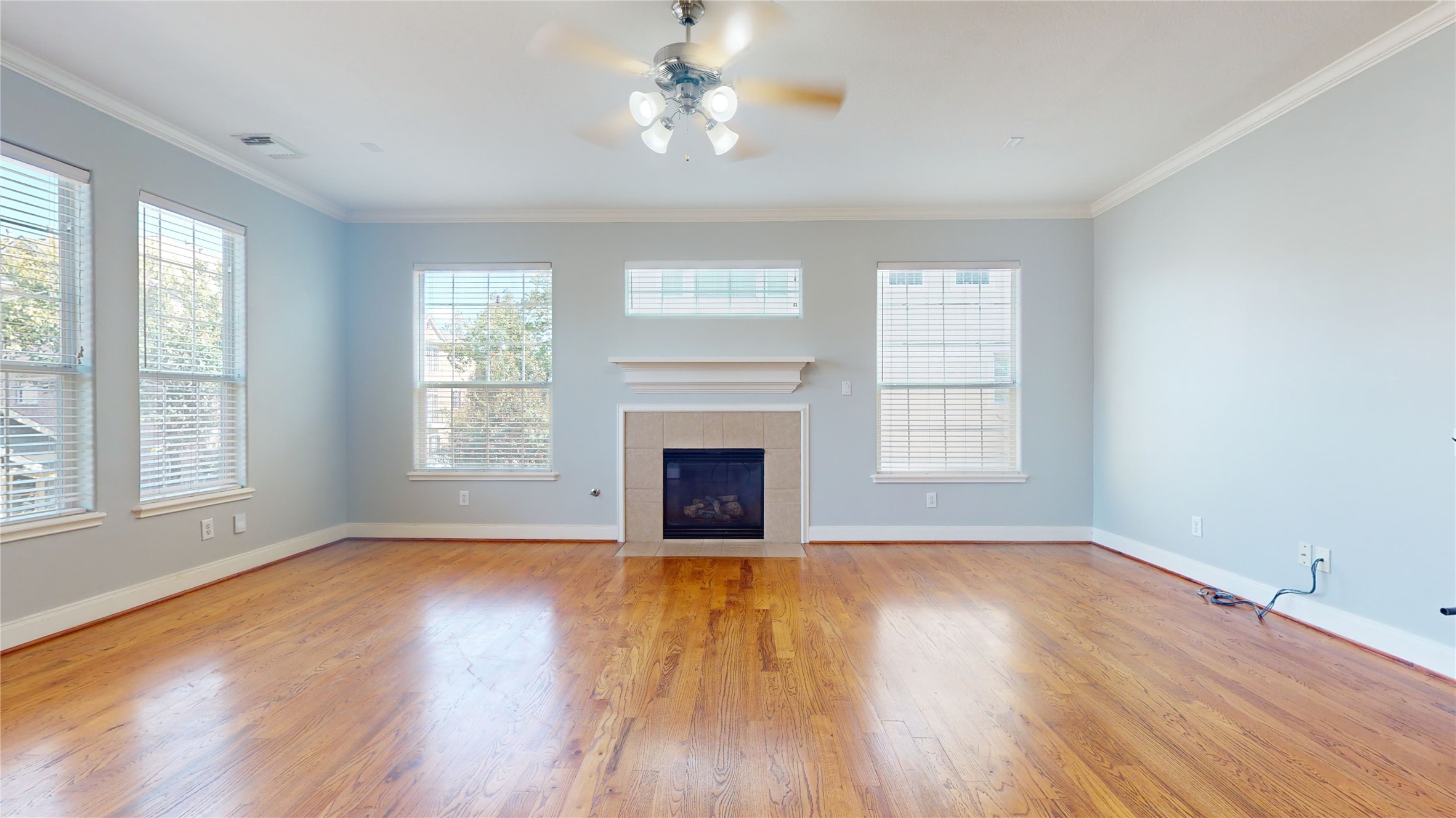 328 Malone Street Houston, TX 77007 - Photo 18 of 50 a view of empty room with wooden floor fireplace and windows