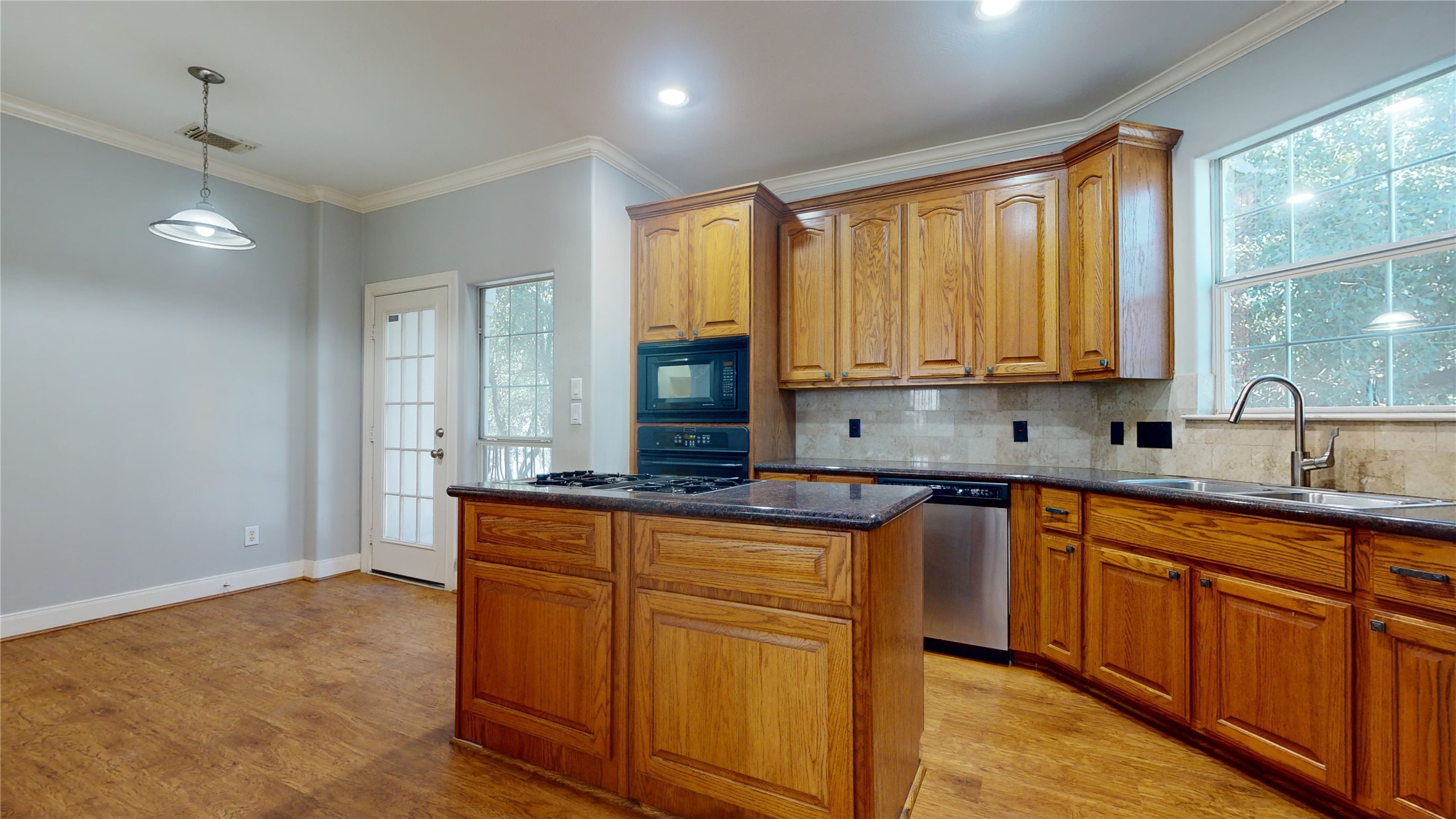 328 Malone Street Houston, TX 77007 - Photo 22 of 50 a kitchen with stainless steel appliances granite countertop wooden cabinets a sink and dishwasher with wooden floor