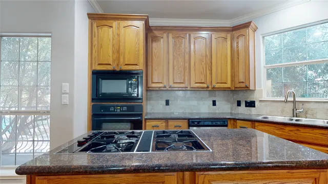 a kitchen with stainless steel appliances granite countertop a stove a sink and a granite counter tops
