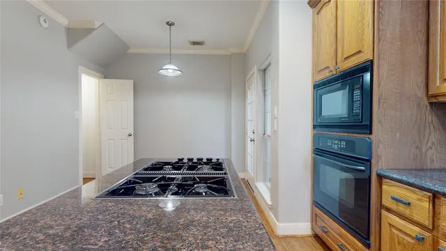 a kitchen with stove and cabinets