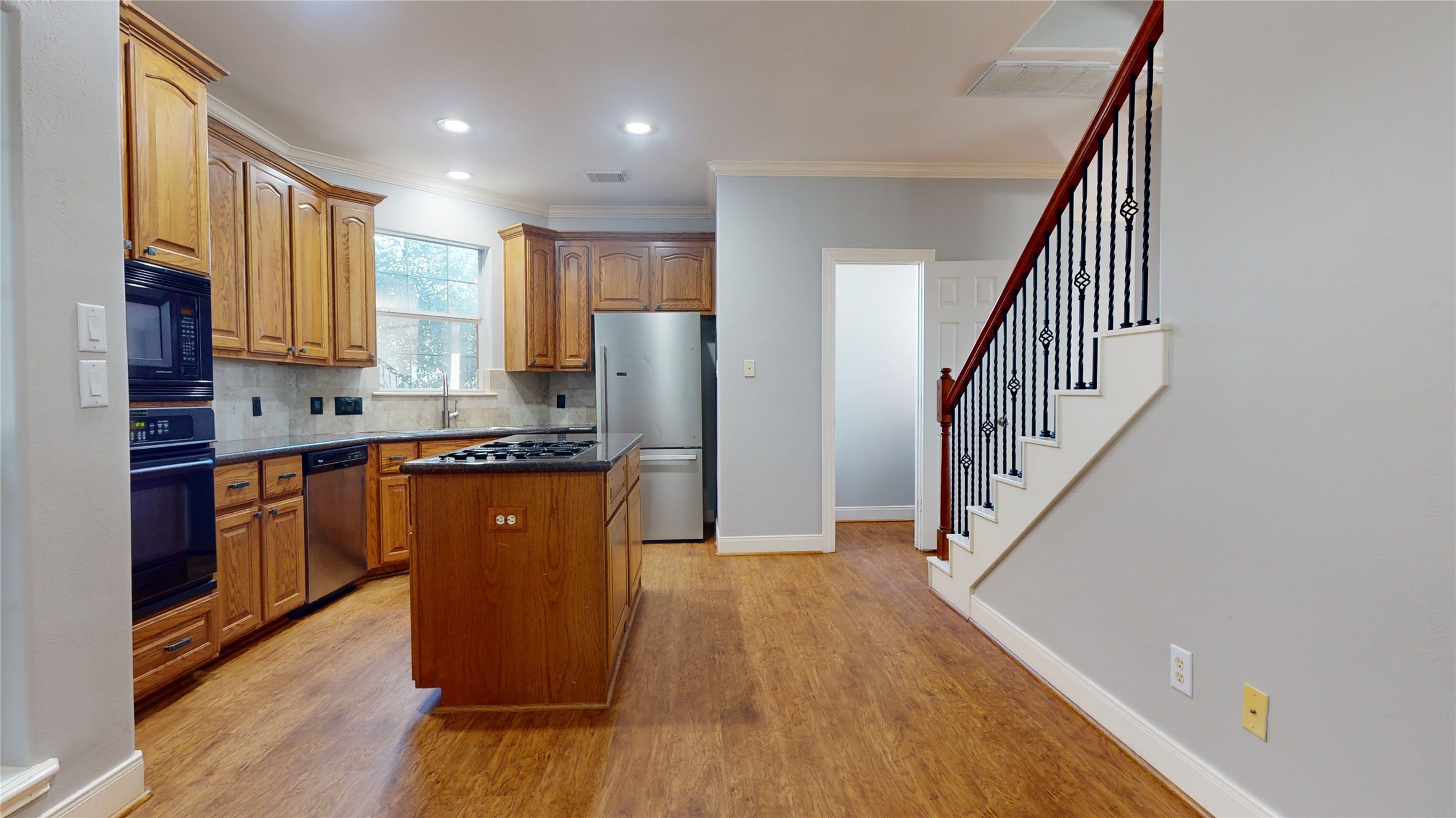 328 Malone Street Houston, TX 77007 - Photo 27 of 50 a kitchen with sink a refrigerator and wooden floor