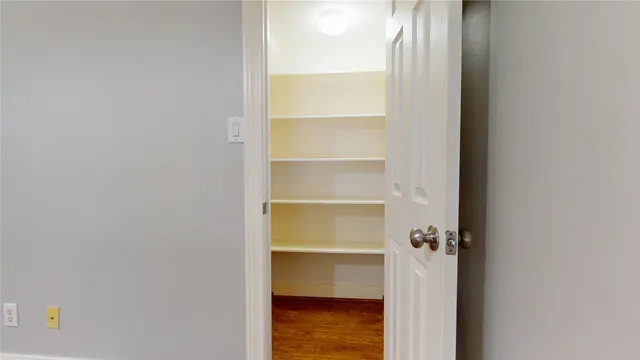 a view of walk in closet with empty racks