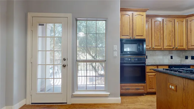 a kitchen with stainless steel appliances granite countertop a refrigerator and a stove top oven