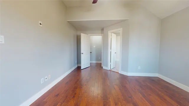 a view of a room with wooden floor