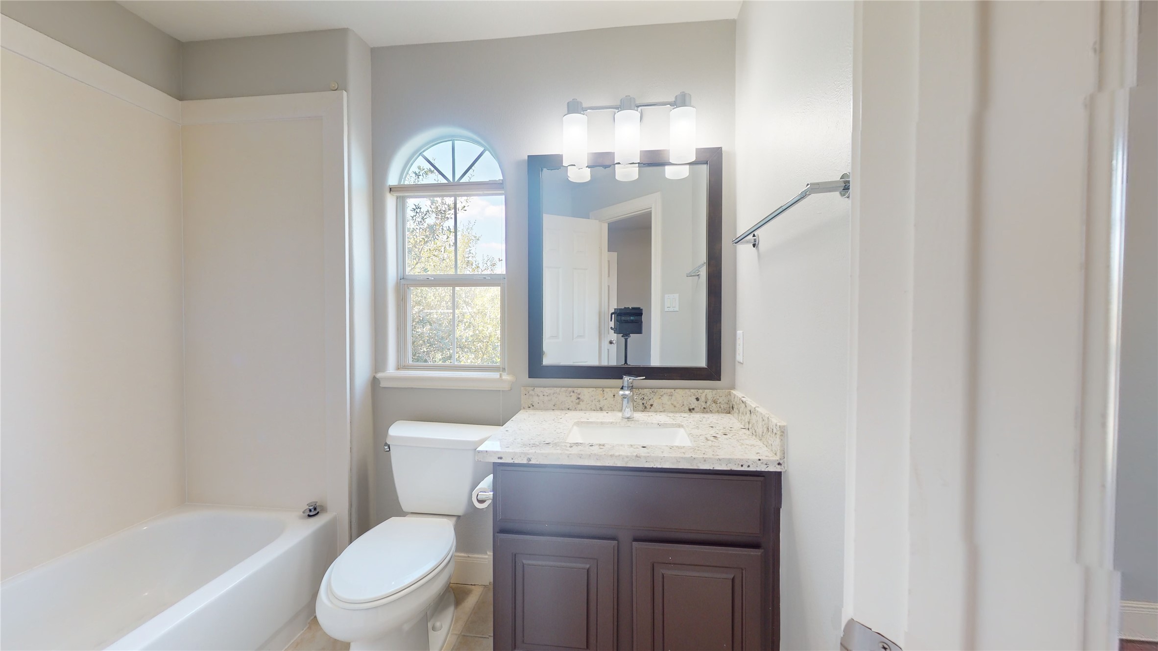 328 Malone Street Houston, TX 77007 - Photo 46 of 50 a bathroom with a granite countertop toilet a sink and a mirror