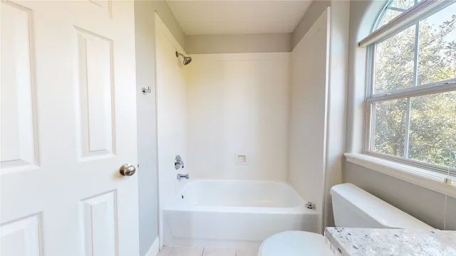 a bathroom with a toilet bathtub and shower