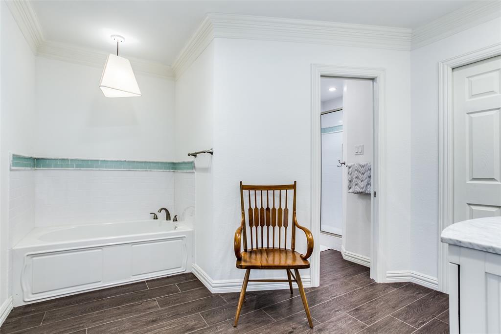 8619 Angora Street Dallas, TX 75218 - Photo 18 of 24 Bathroom featuring a tub, hardwood / wood-style floors, vanity, and crown molding