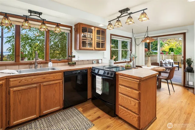 a kitchen with a sink stove and cabinets