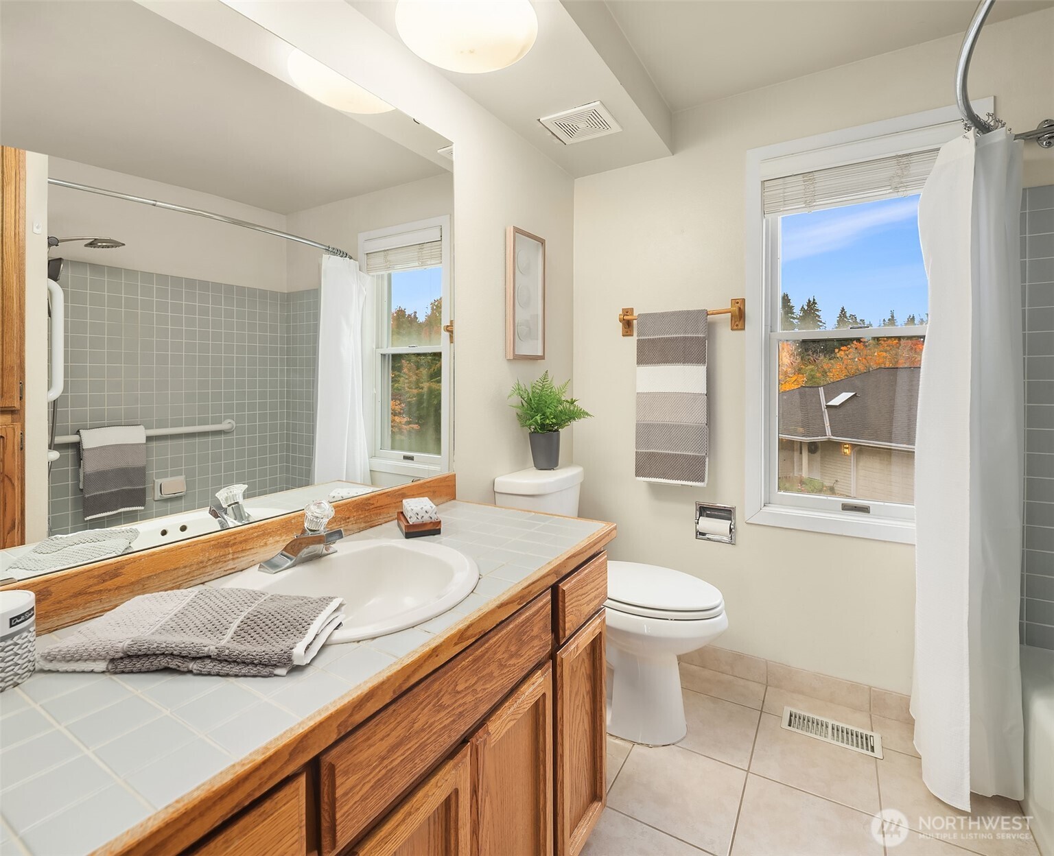 637 Elm Place Edmonds, WA 98020 - Photo 24 of 34 a bathroom with a granite countertop sink mirror vanity and toilet