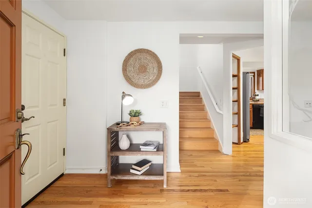 a view of a hallway with wooden floor and entryway
