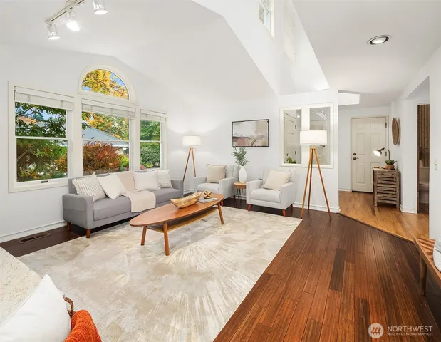 a living room with furniture and a wooden floor