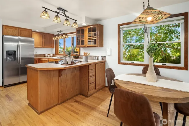 a kitchen with a sink a counter top space and stainless steel appliances