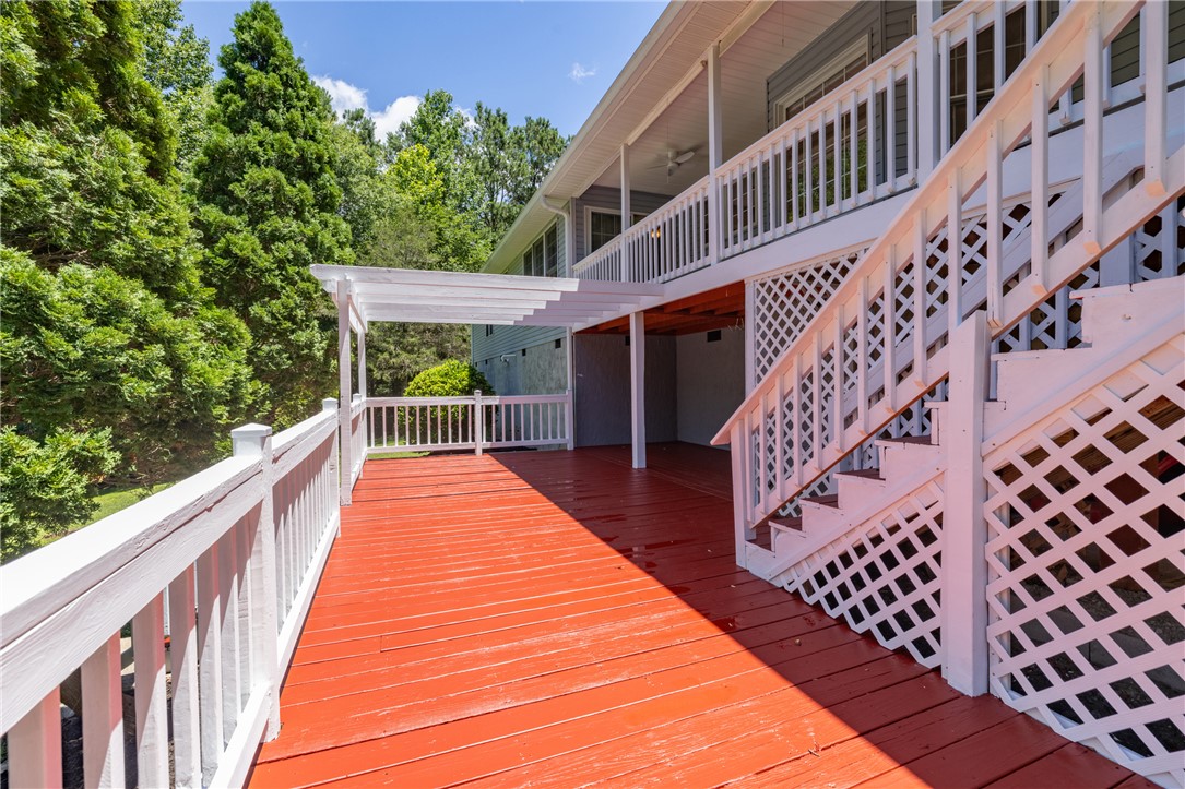 429 Burns Mill Road West Union, SC 29696 - Photo 36 of 49 An inviting wooden deck, freshly stained a vibrant red, offers a serene outdoor living space.