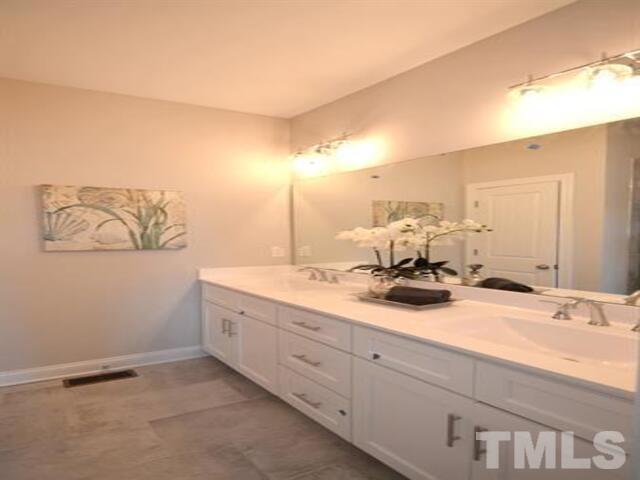 102 Philip's Square Chapel Hill, NC 27516 - Photo 13 of 25 a bathroom with a double vanity sink and a mirror