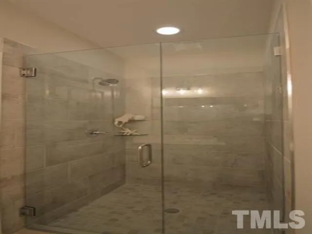 a bathroom with a bathtub shower sink vanity and toilet
