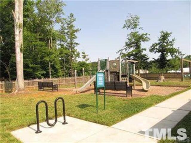 102 Philip's Square Chapel Hill, NC 27516 - Photo 24 of 25 a view of a swimming pool with a bench and trees in the patio