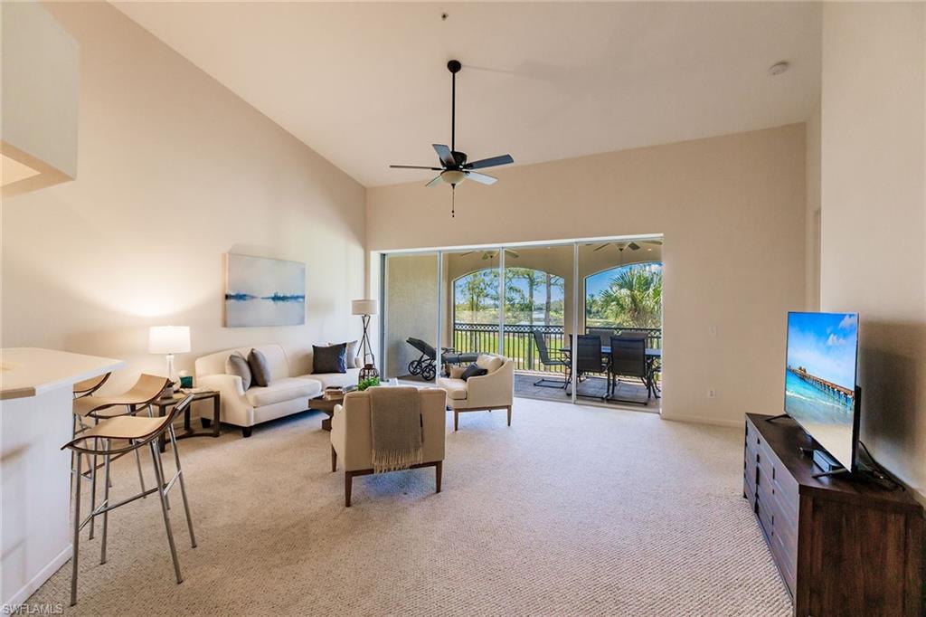3940 Deer Crossing Court, Unit 4203 Naples, FL 34114 - Photo 11 of 46 a living room with furniture a ceiling fan and a flat screen tv