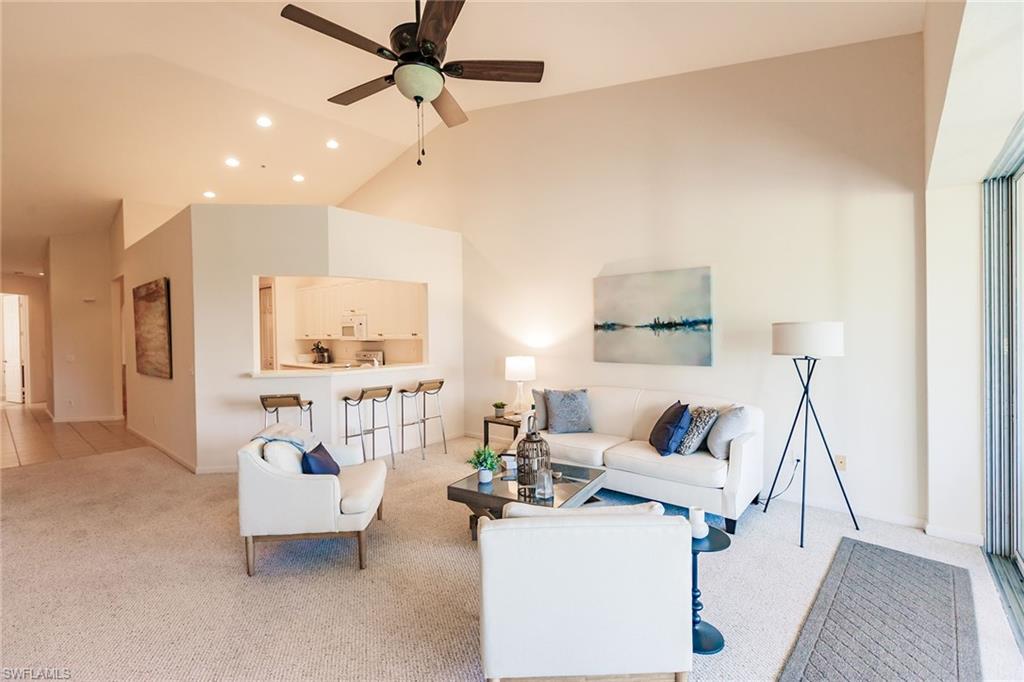 3940 Deer Crossing Court, Unit 4203 Naples, FL 34114 - Photo 12 of 46 a living room with furniture and a wooden floor