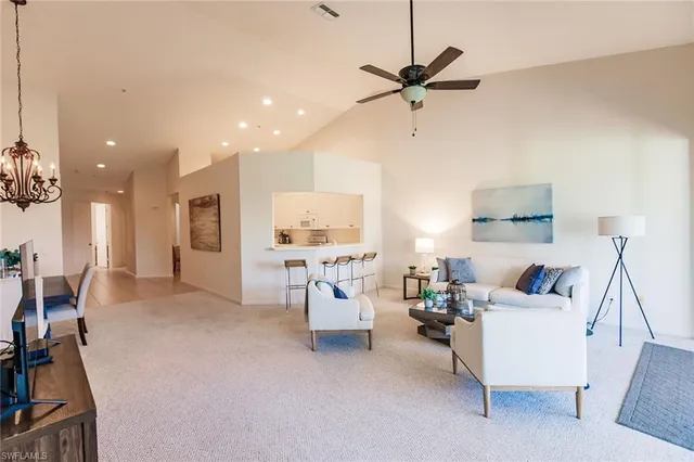 a living room with furniture a floor to ceiling window and a flat screen tv