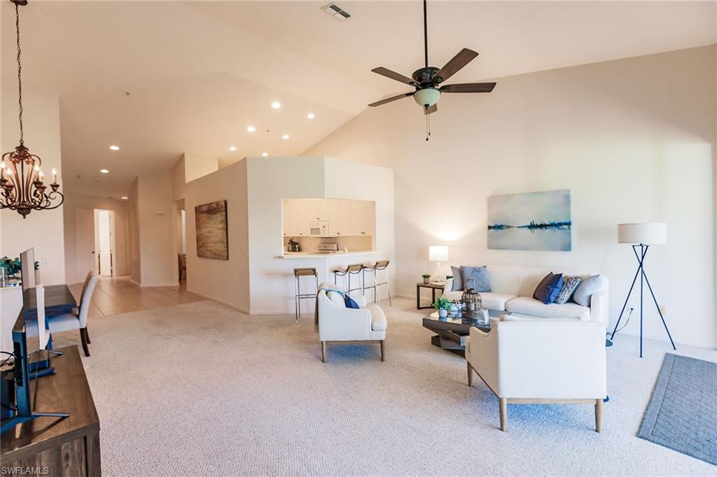 3940 Deer Crossing Court, Unit 4203 Naples, FL 34114 - Photo 13 of 46 a living room with furniture and a large window