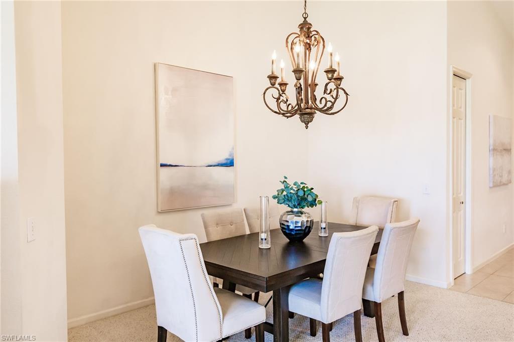 3940 Deer Crossing Court, Unit 4203 Naples, FL 34114 - Photo 17 of 46 a view of a dining room with furniture and front door