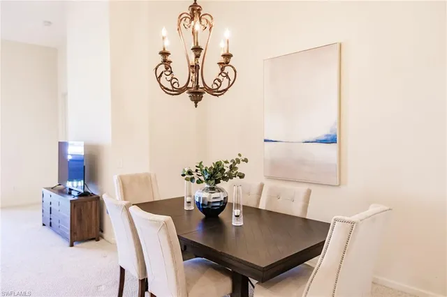a view of a dining room with furniture wooden floor and a chandelier
