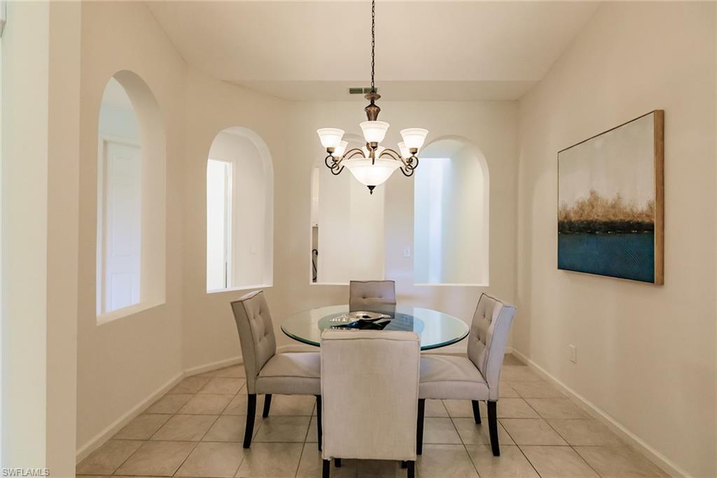 3940 Deer Crossing Court, Unit 4203 Naples, FL 34114 - Photo 23 of 46 a dining room with furniture and window