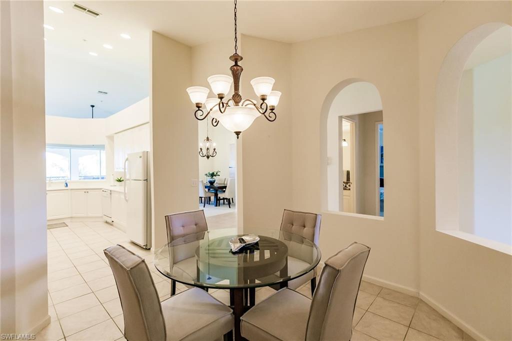 3940 Deer Crossing Court, Unit 4203 Naples, FL 34114 - Photo 25 of 46 a view of a dining room with furniture and chandelier