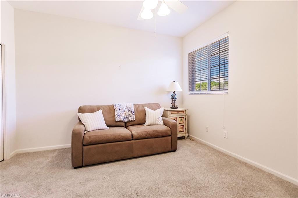 3940 Deer Crossing Court, Unit 4203 Naples, FL 34114 - Photo 26 of 46 a living room with furniture and a window