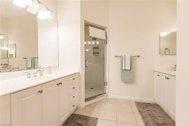 a bathroom with a shower sink and mirror