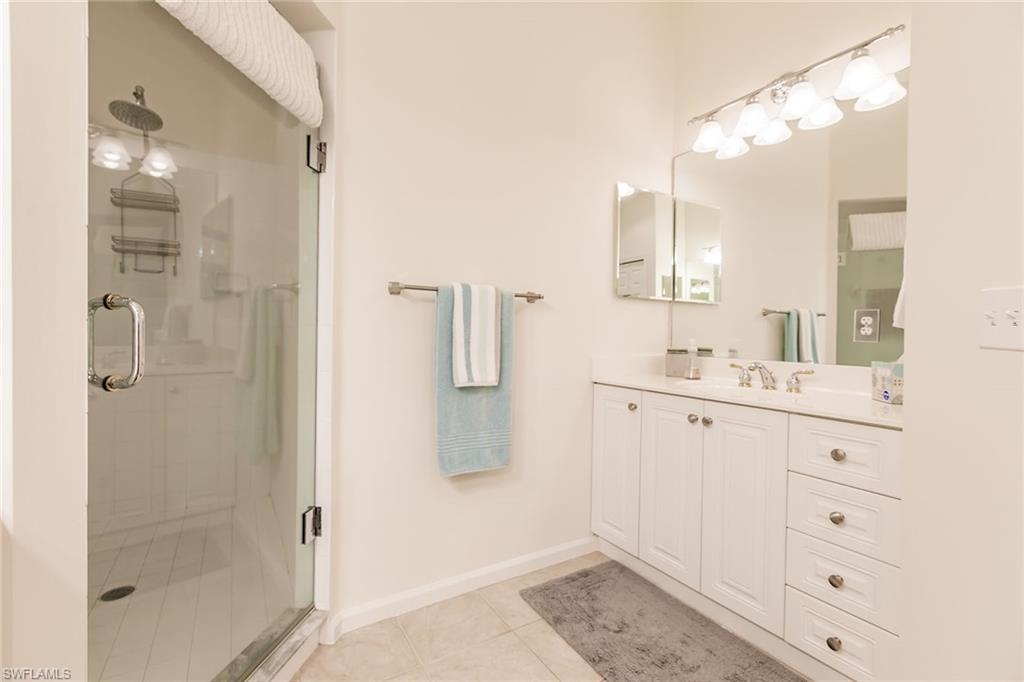 3940 Deer Crossing Court, Unit 4203 Naples, FL 34114 - Photo 32 of 46 a bathroom with a shower sink and mirror