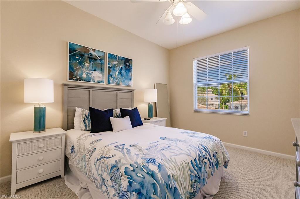 3940 Deer Crossing Court, Unit 4203 Naples, FL 34114 - Photo 35 of 46 a bedroom with a bed and a window