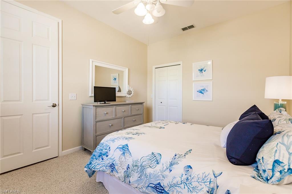 3940 Deer Crossing Court, Unit 4203 Naples, FL 34114 - Photo 36 of 46 a bedroom with a bed and a mirror