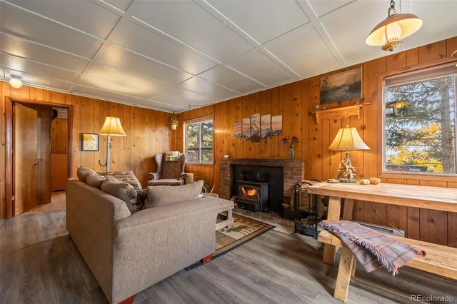 a front view of a house with swimming pool and furniture