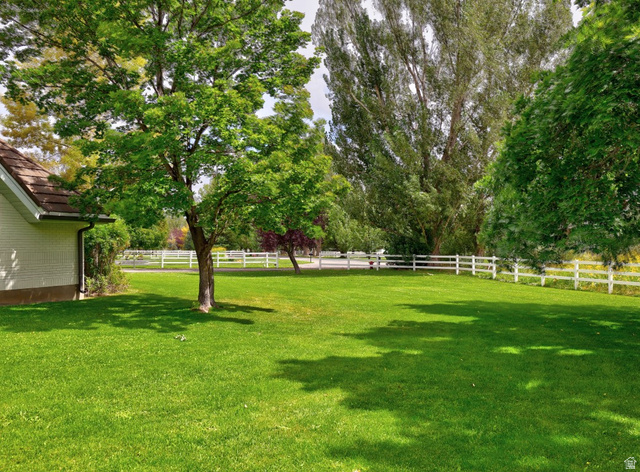 180 Farm Road Midway, UT 84049 - Photo 91 of 99 Expansive green lawn with mature trees and a white three-rail fence