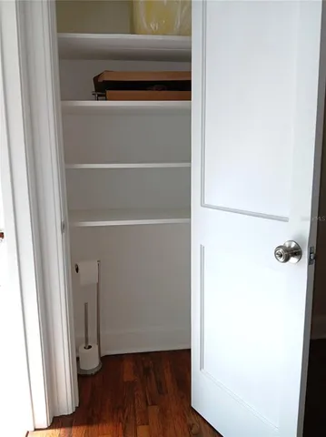 a view of walk in closet with wooden floor
