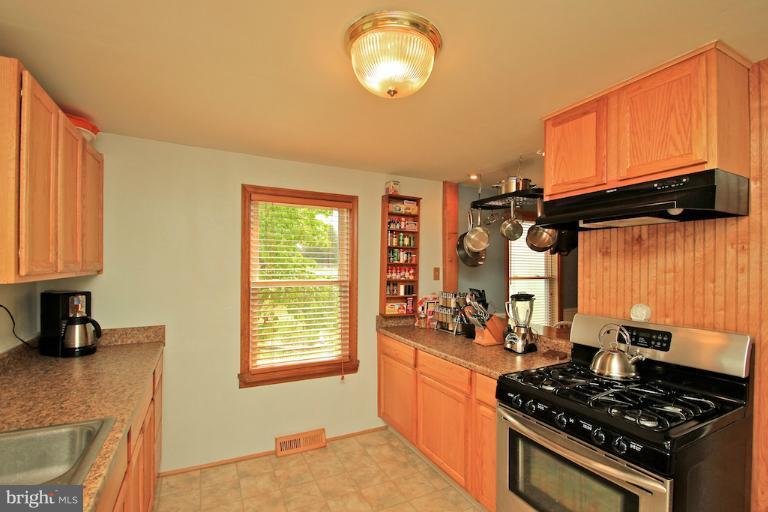 19628 Anderson Mill Road Beaverdam, VA 23015 - Photo 13 of 29 a kitchen with a stove a sink and a window