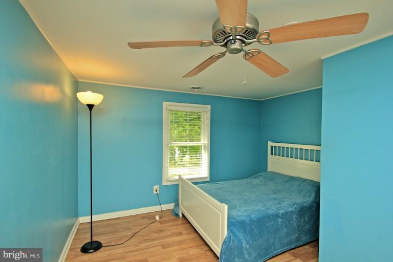 19628 Anderson Mill Road Beaverdam, VA 23015 - Photo 16 of 29 a bedroom with a bed and a chandelier