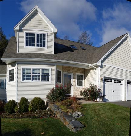 20 Bridge Road, Unit 29 Northampton, MA 01062 - Photo 3 of 30 a front view of a house with a yard and garage