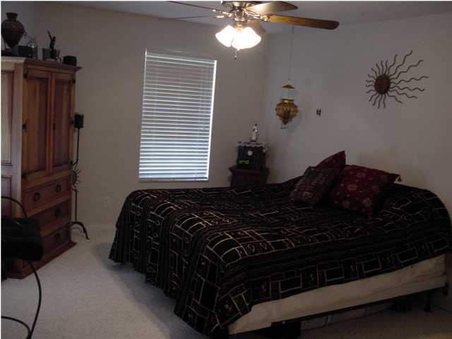 82 East Wild Briar Road Santa Rosa Beach, FL 32459 - Photo 11 of 26 a bed sitting in a bedroom next to a window