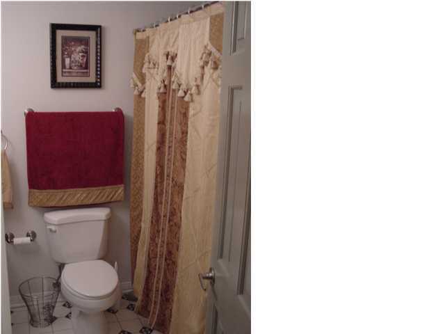82 East Wild Briar Road Santa Rosa Beach, FL 32459 - Photo 15 of 26 a bathroom with a toilet and a shower curtain
