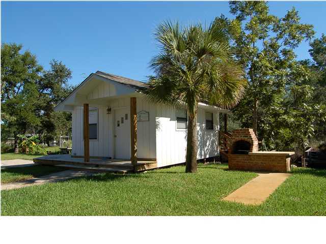 82 East Wild Briar Road Santa Rosa Beach, FL 32459 - Photo 17 of 26 a black and white house with a yard
