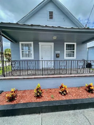 a front view of a house with outdoor seating